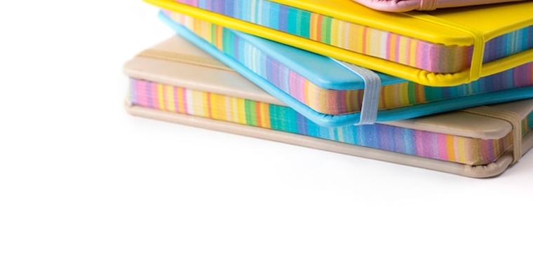 A stack of colourful exercise books